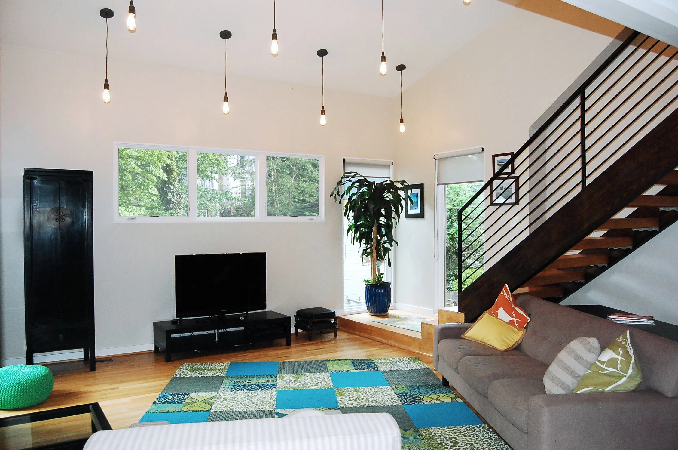VUE CORNER STAIRCASE AND DOUBLE CEILINGS WITH MULTIPLE PENDANT LIGHTS 