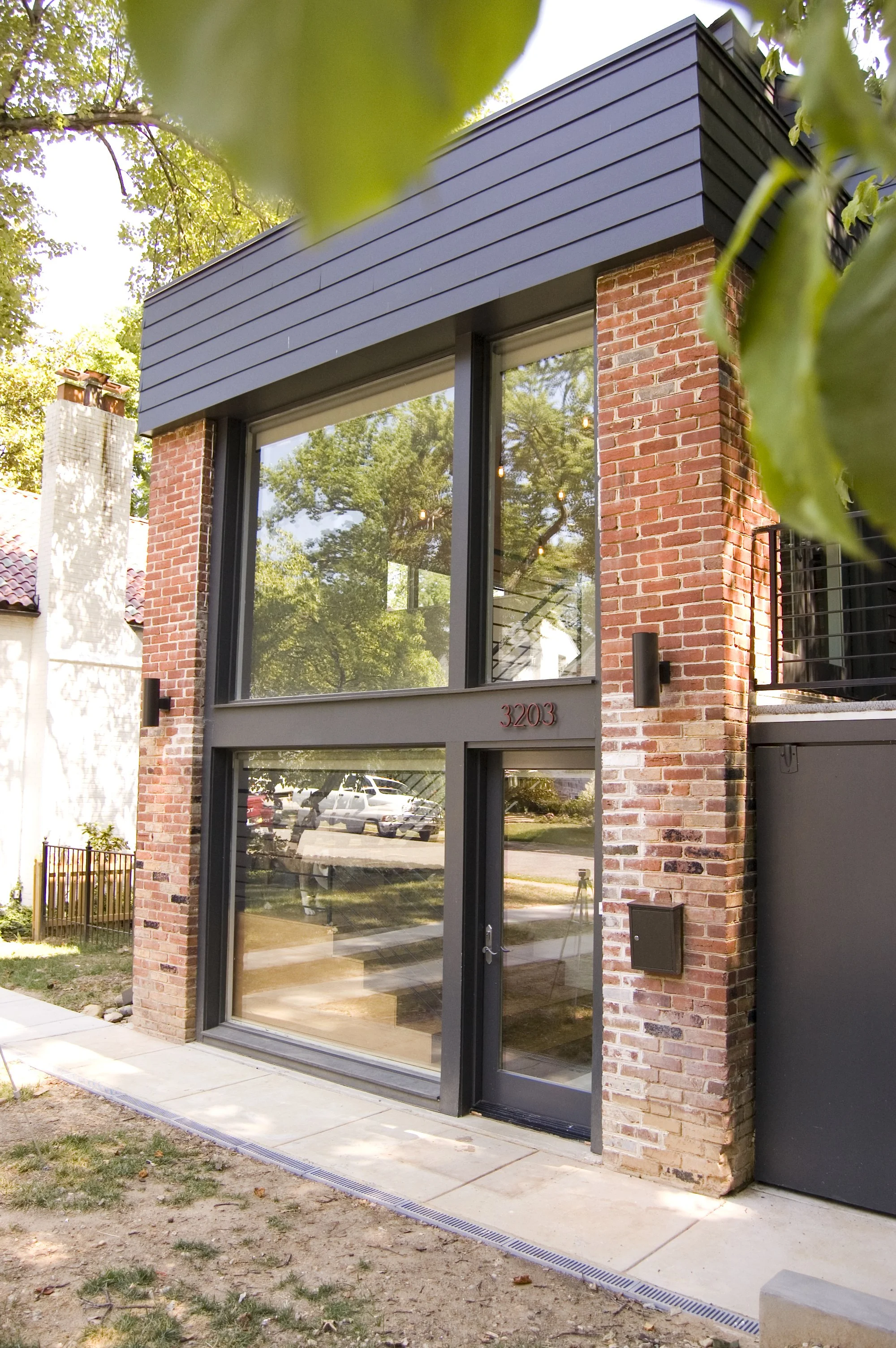 NEW GLASS FACADE IN EXISTING GARAGE AND PORCH OPENINGS 