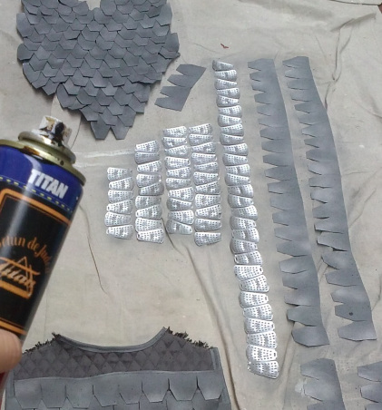 "... The flexible armor was thought out to give Ron Campbell, who plays Don Quixote, the ability to do somersaults or whatever shenanigans he wanted. The individual pieces of vegetable steamers were separated, flattened, dulled, textured with light speckling of spray paint, sealed, and then layered in and sewn down among the faux suede fabric I had already cut into scale shapes, treated and sewn down onto a base of quilted material thanks to my trusty industrial Singer…" Maria Chenut