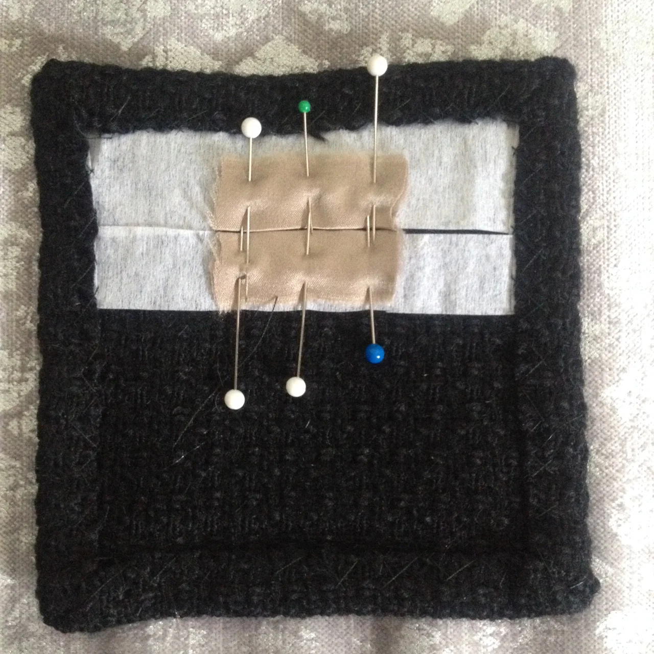 2. Create two welts by cutting lengths of lining and folding in half lengthwise. The folded edges should be placed facing each other, over the center of the buttonhole.