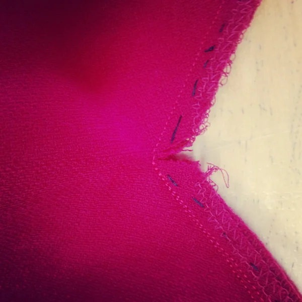 4. Before sewing the other side of the v shape, the skirt is clipped along the seam allowance, at the center of the v.