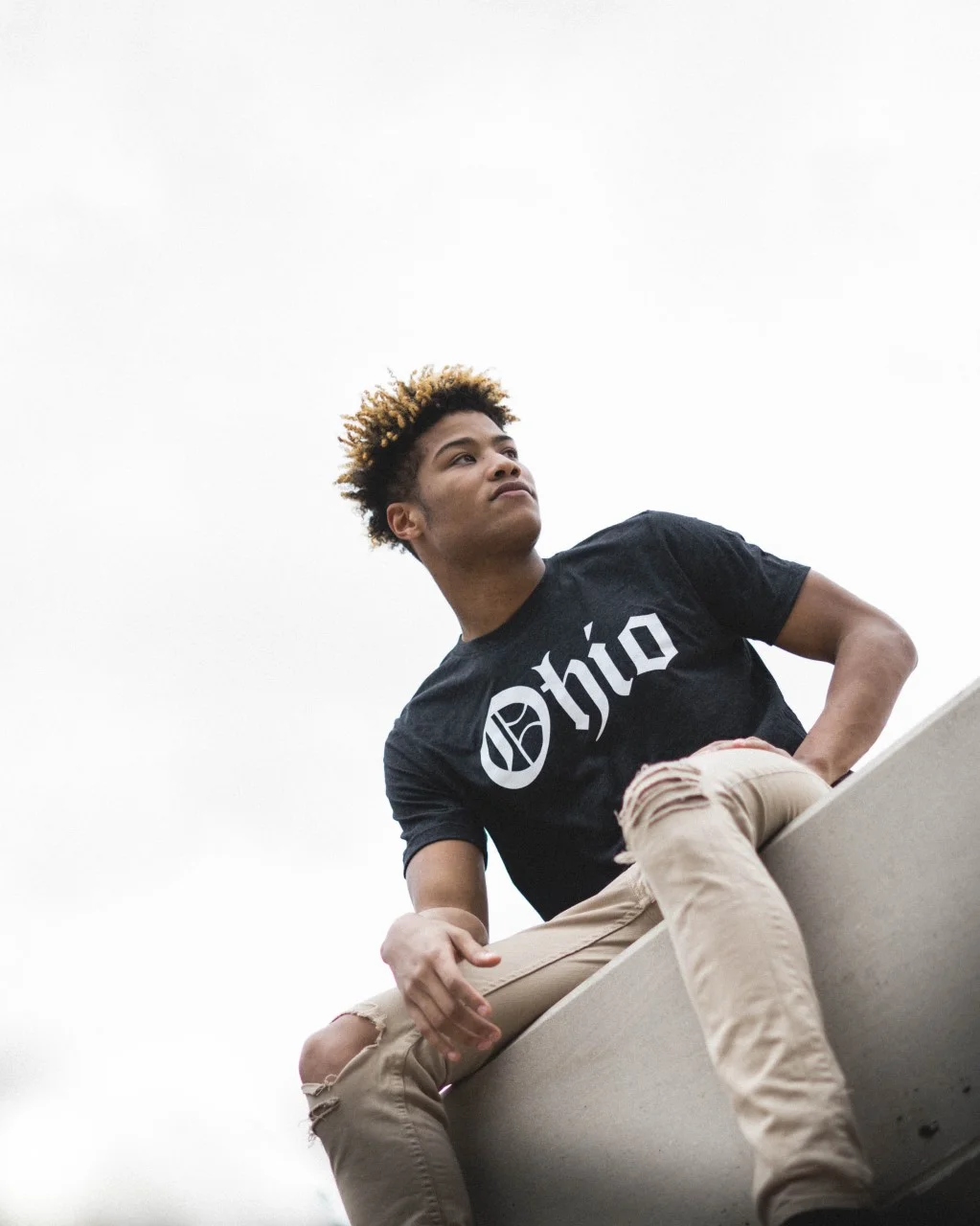 Ohio Dynasty Apparel - Royalty tee - charcoal white - old English font - model sitting on ledge