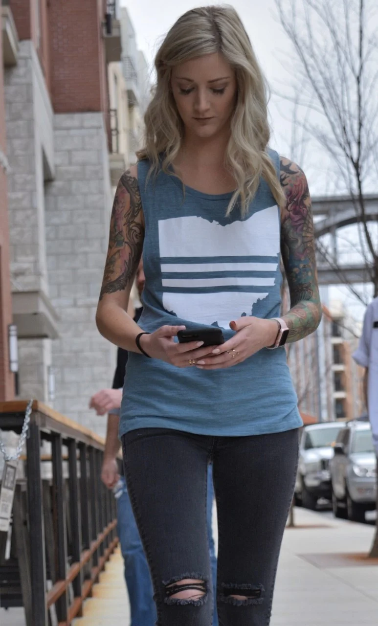 Ohio Dynasty Apparel - Ohio Stripes Muscle Tank Women's slate teal - model walking outside texting tattoos