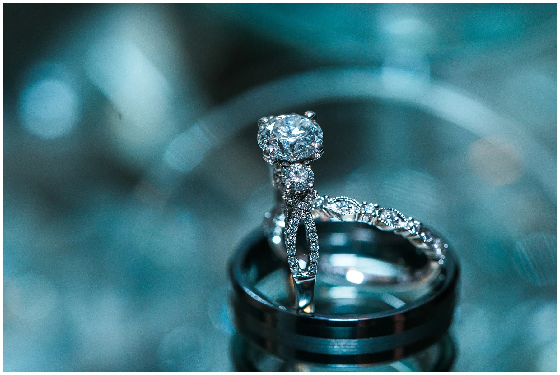 sparkly engagement ring, wedding band, and groom's band