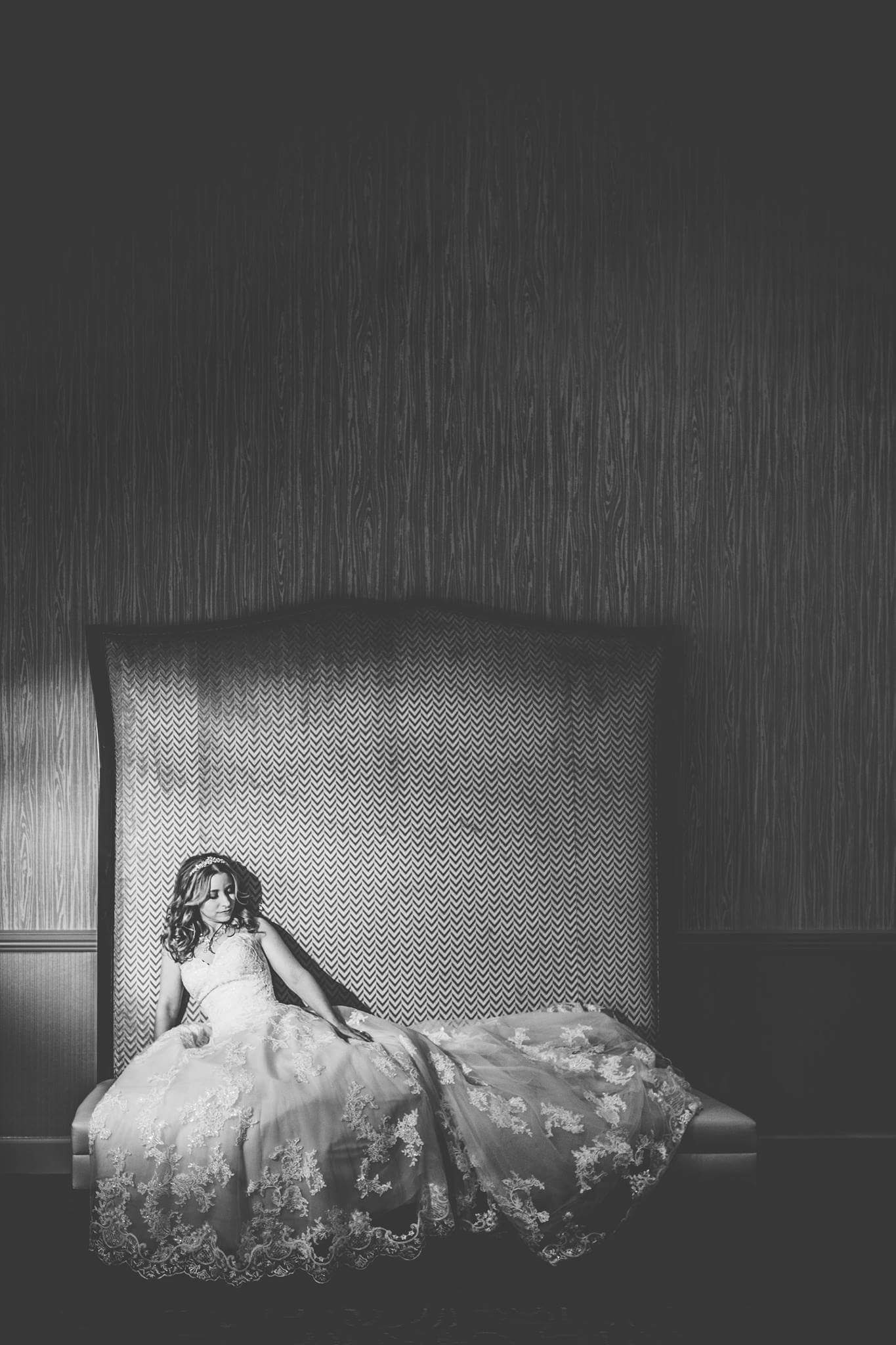 beautiful bride in a decadent lace dress taking a moment to enjoy her reception