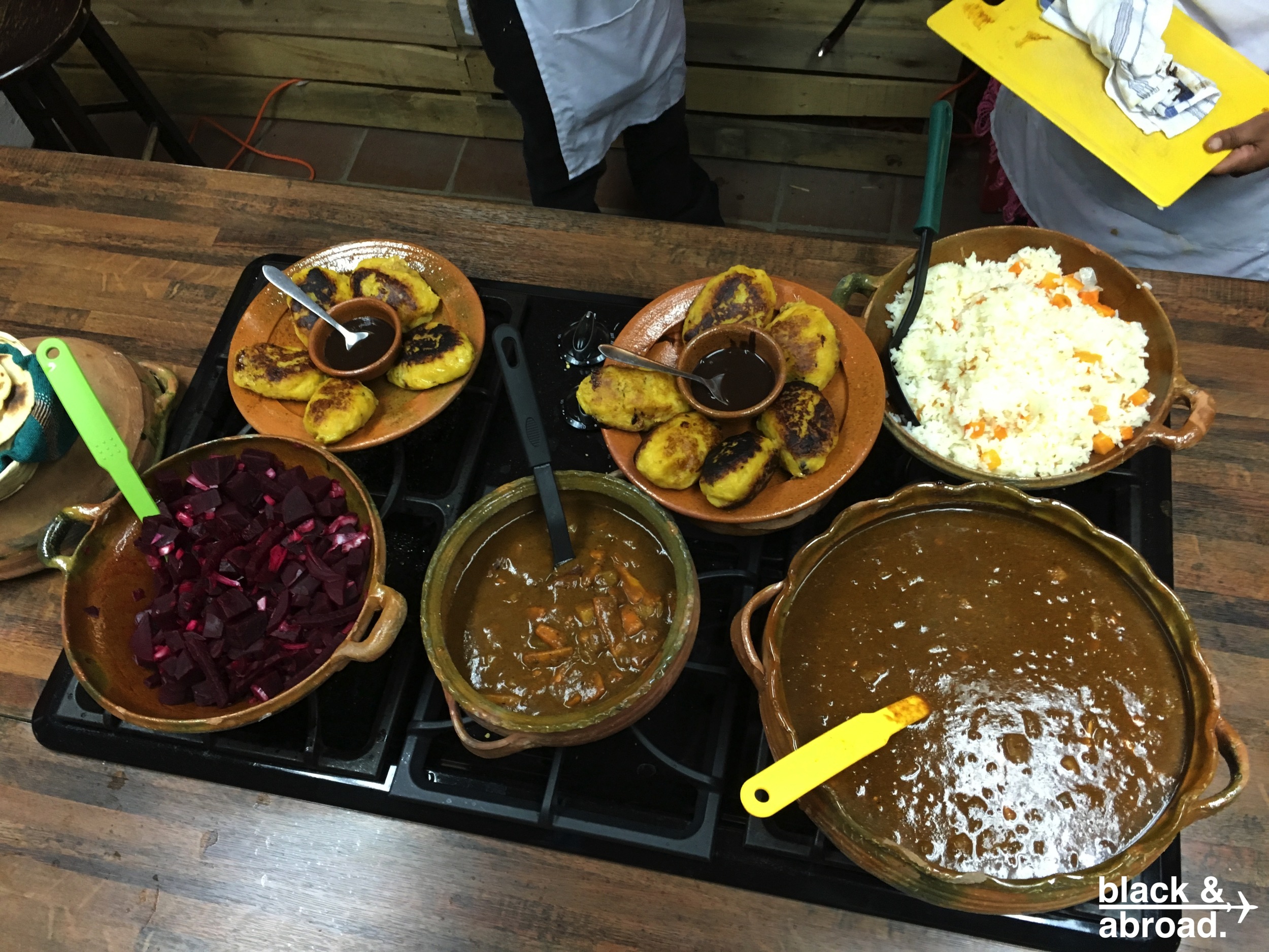 The full spread: (clockwise, starting at the top right) Guatemalan rice, Pepian con pollo, Pepian no pollo, beet salad, and rellenitos.