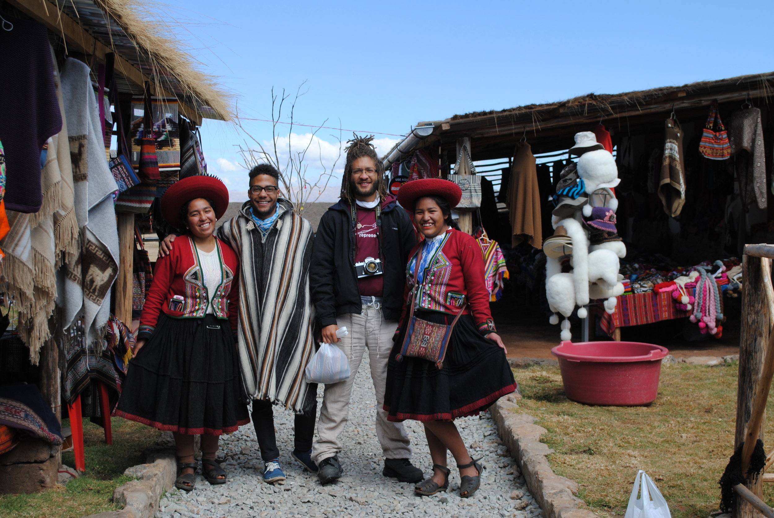 My younger brother and me making new friends in Peru - looks like a family photo.