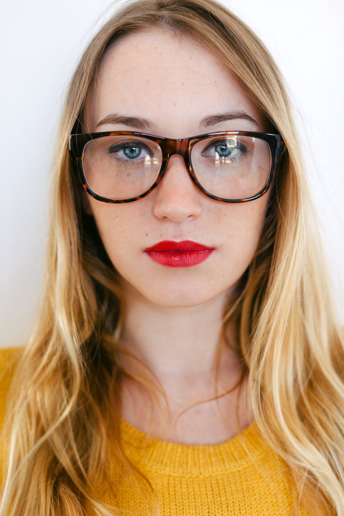 Blonde girl with glasses_Stocksy_Medium.jpg