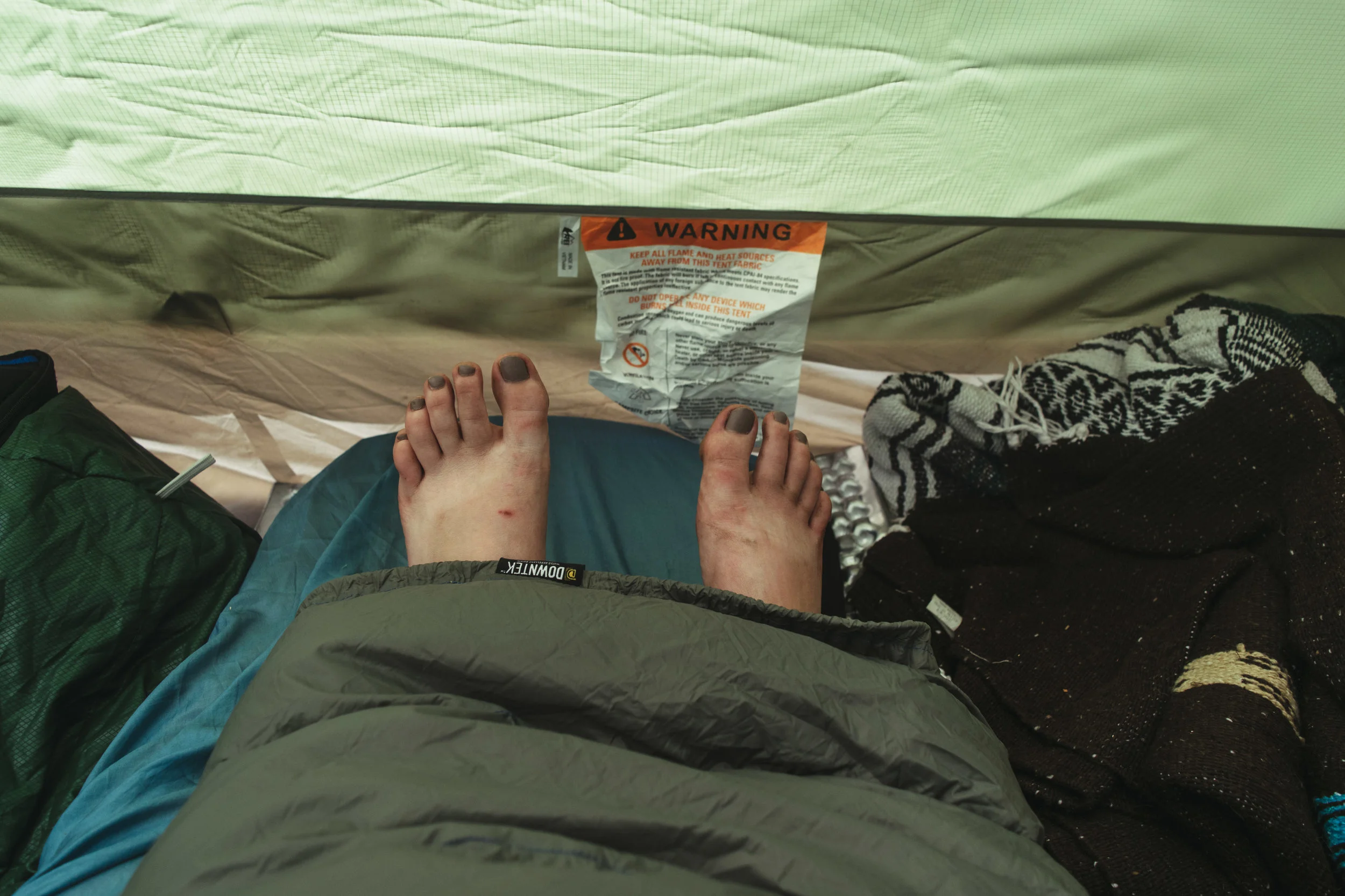 Pardon my gross camp feet, but LOOK I can be snuggled inside AND have my feet out for optimal temperature control!