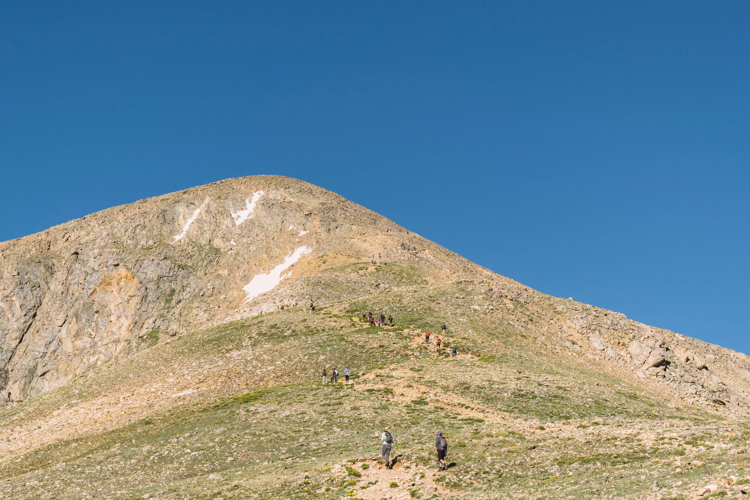 Sam is up towards the top right here somewhere. Also, that’s not the summit of the mountain, you have to go around it and then even further up!