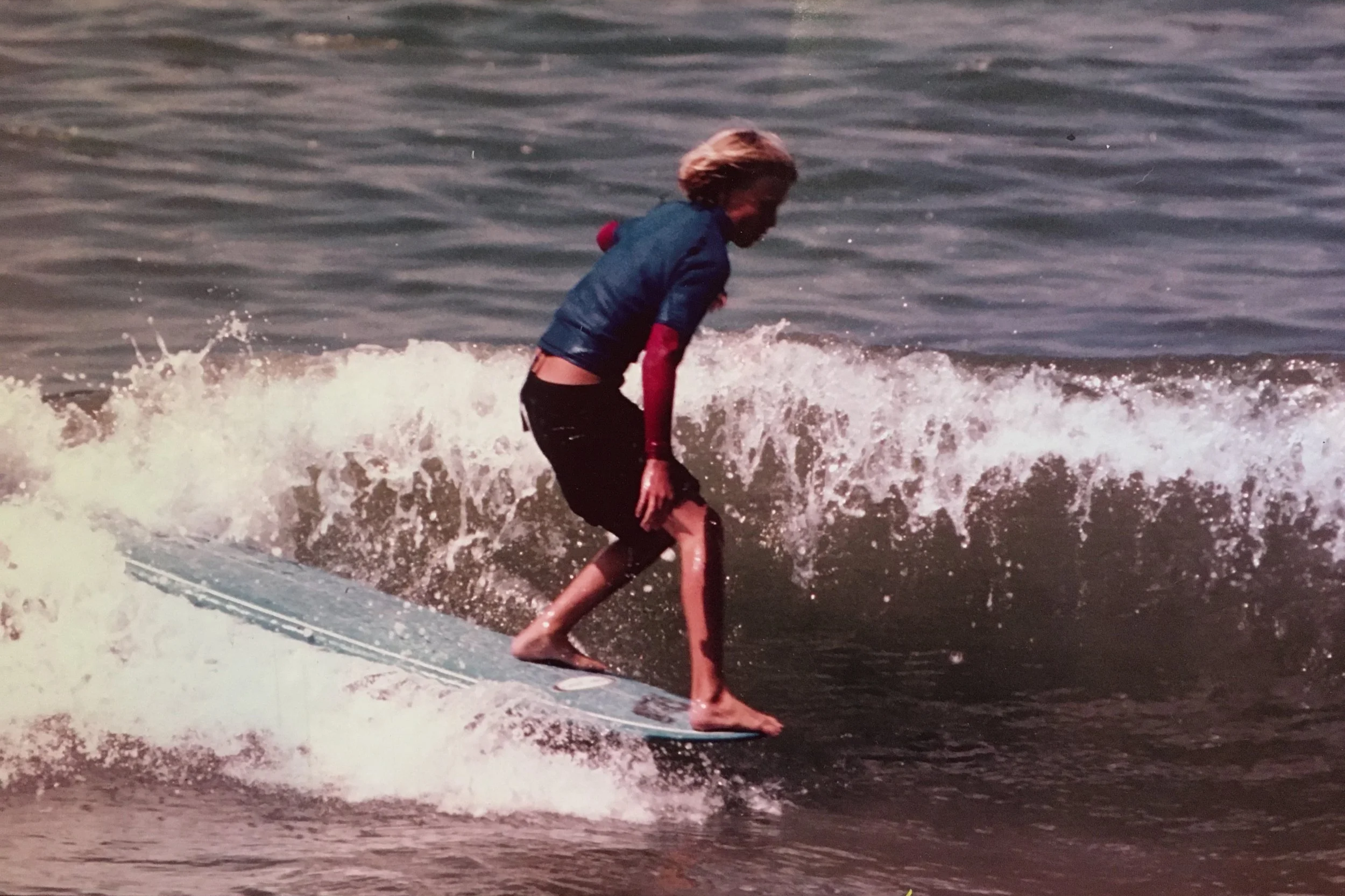 Brock Jones of Jones Shapes Surfboards surfing a Bruce Jones longboard at Bolsa Chica State Beach.