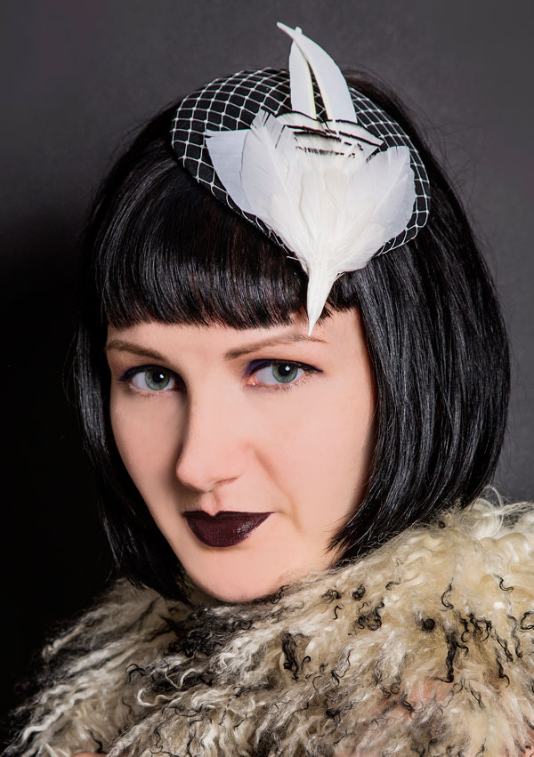Black cocktail hat with white bird and net trim