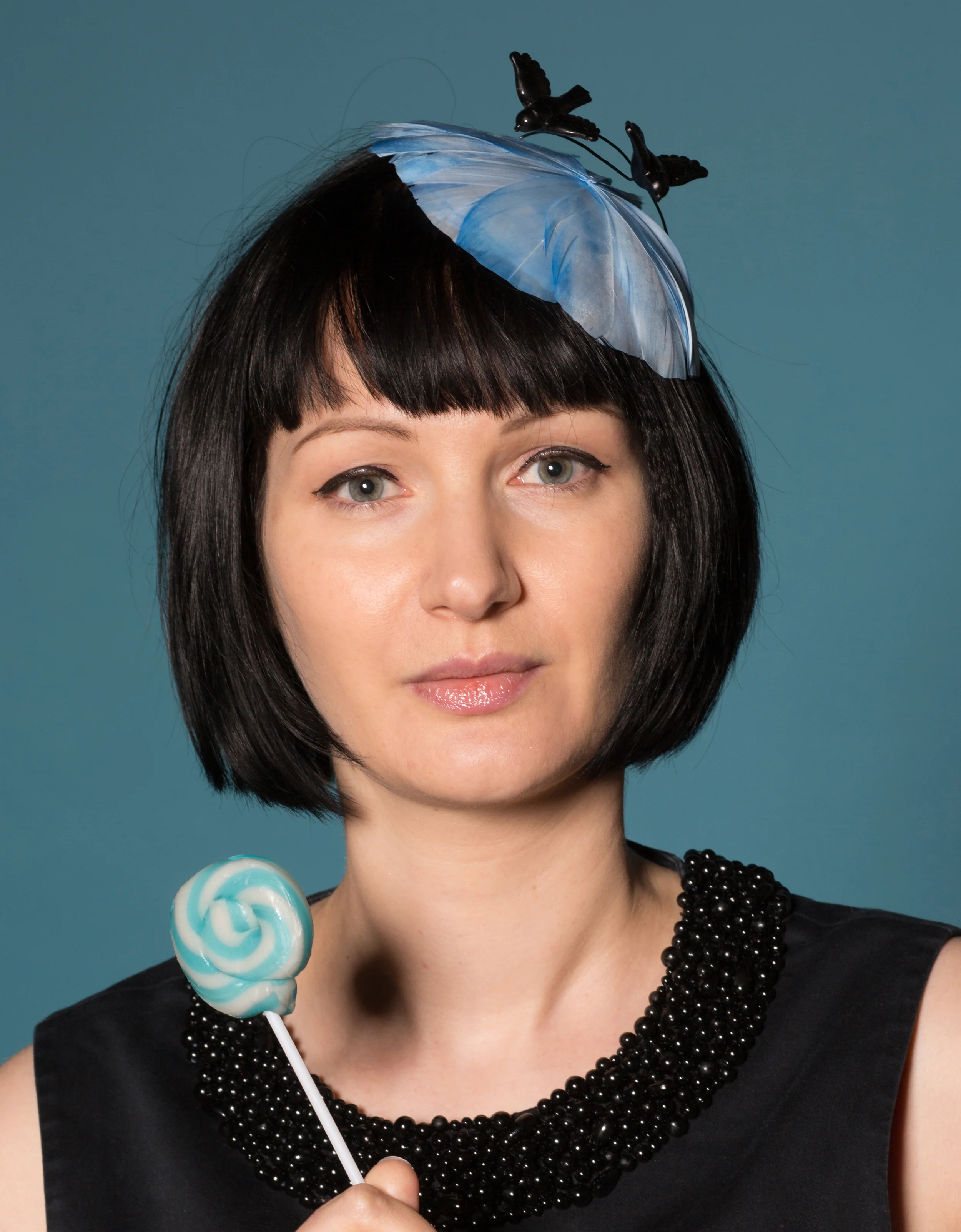 Sky blue feather hat with black birds