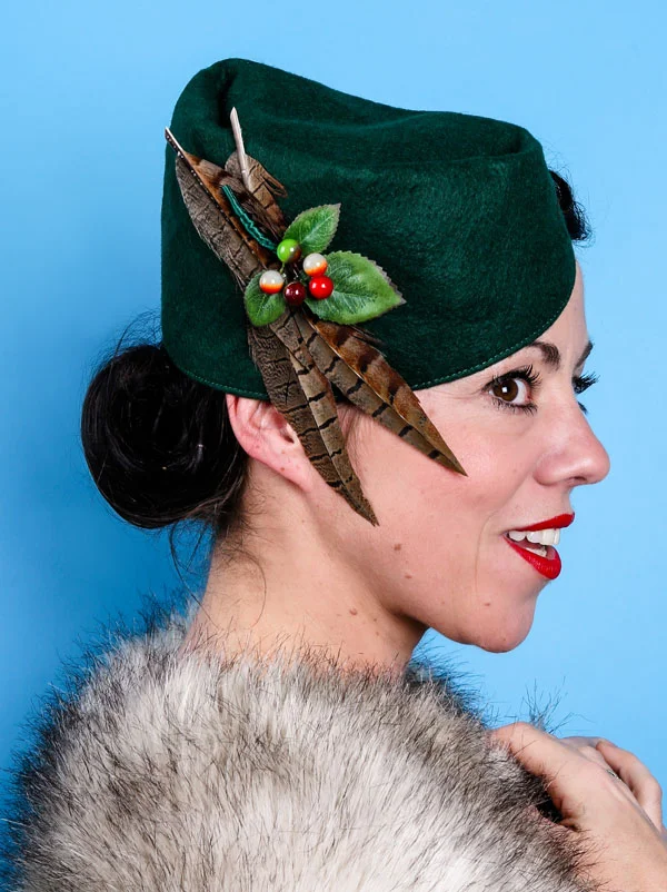 Dark green 1930s style cap with pheasant feathers
