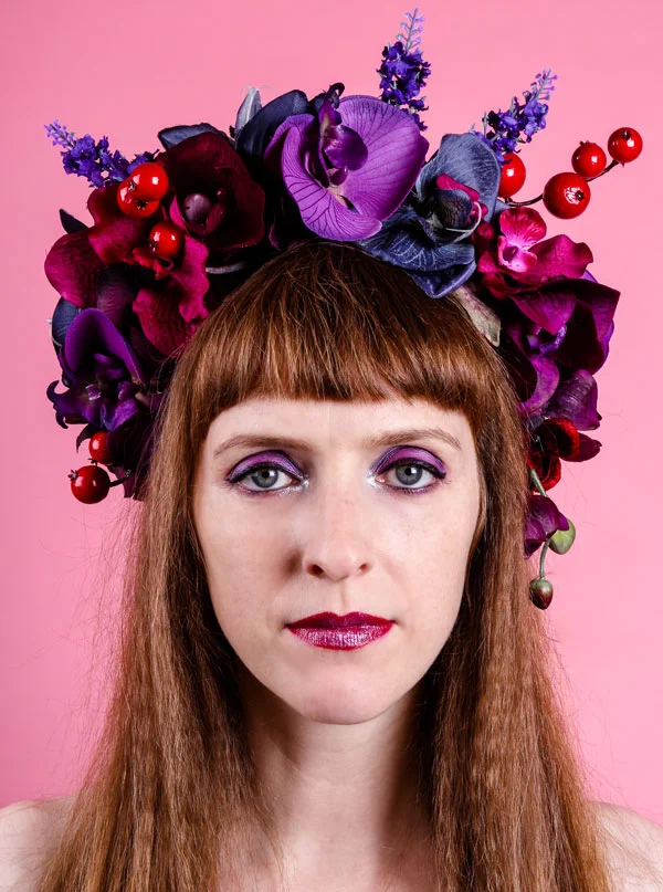 Purple flower headdress with blue and red orchids
