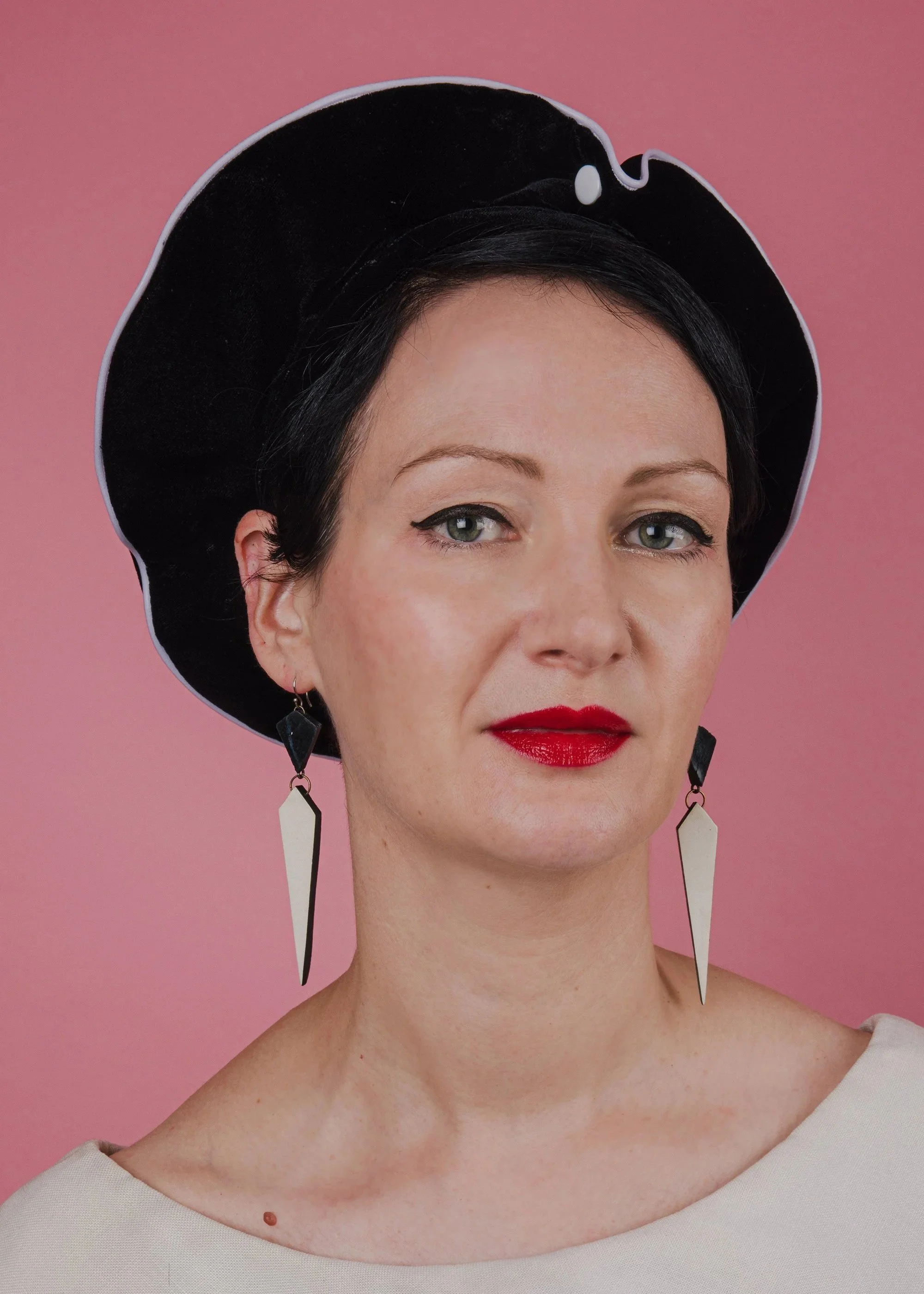 Black velvet beret with white piping and button