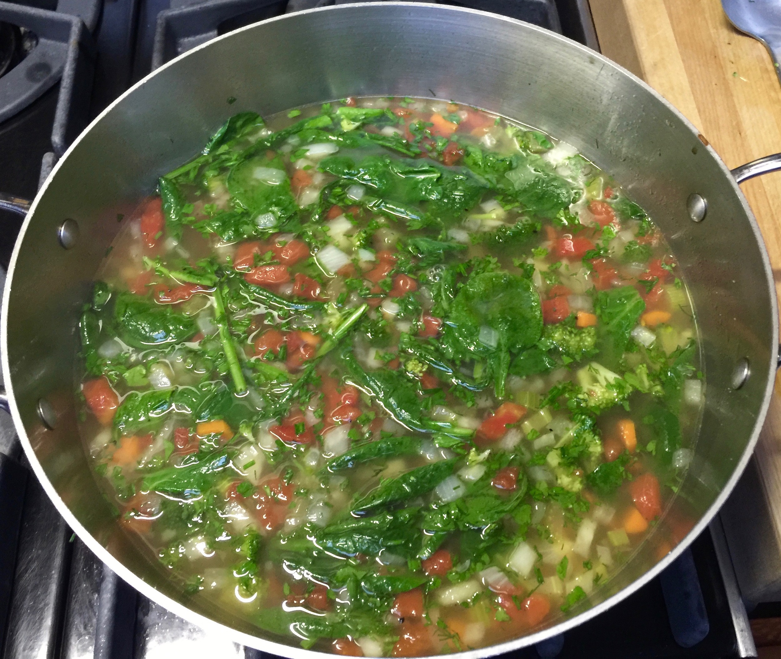 Add spinach, herbs and garlic. Simmer 5 more minutes or until the vegetables are just cooked through.