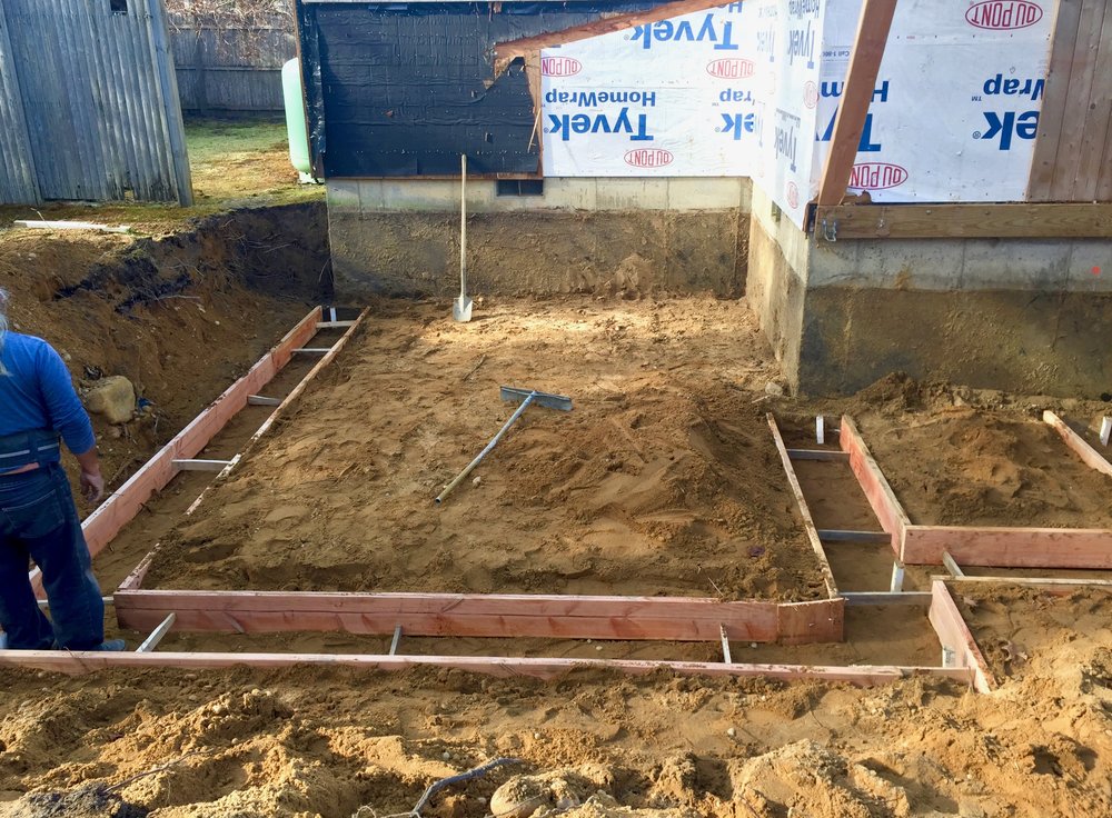 Laying the mold for the footings.