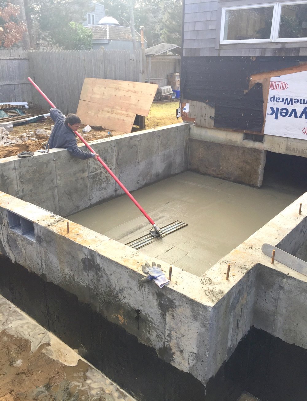 Smoothing the just poured floor.