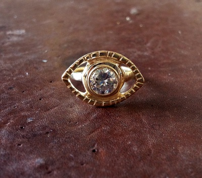  18K gold eye engagement ring with 2.5 carat bezel set diamond