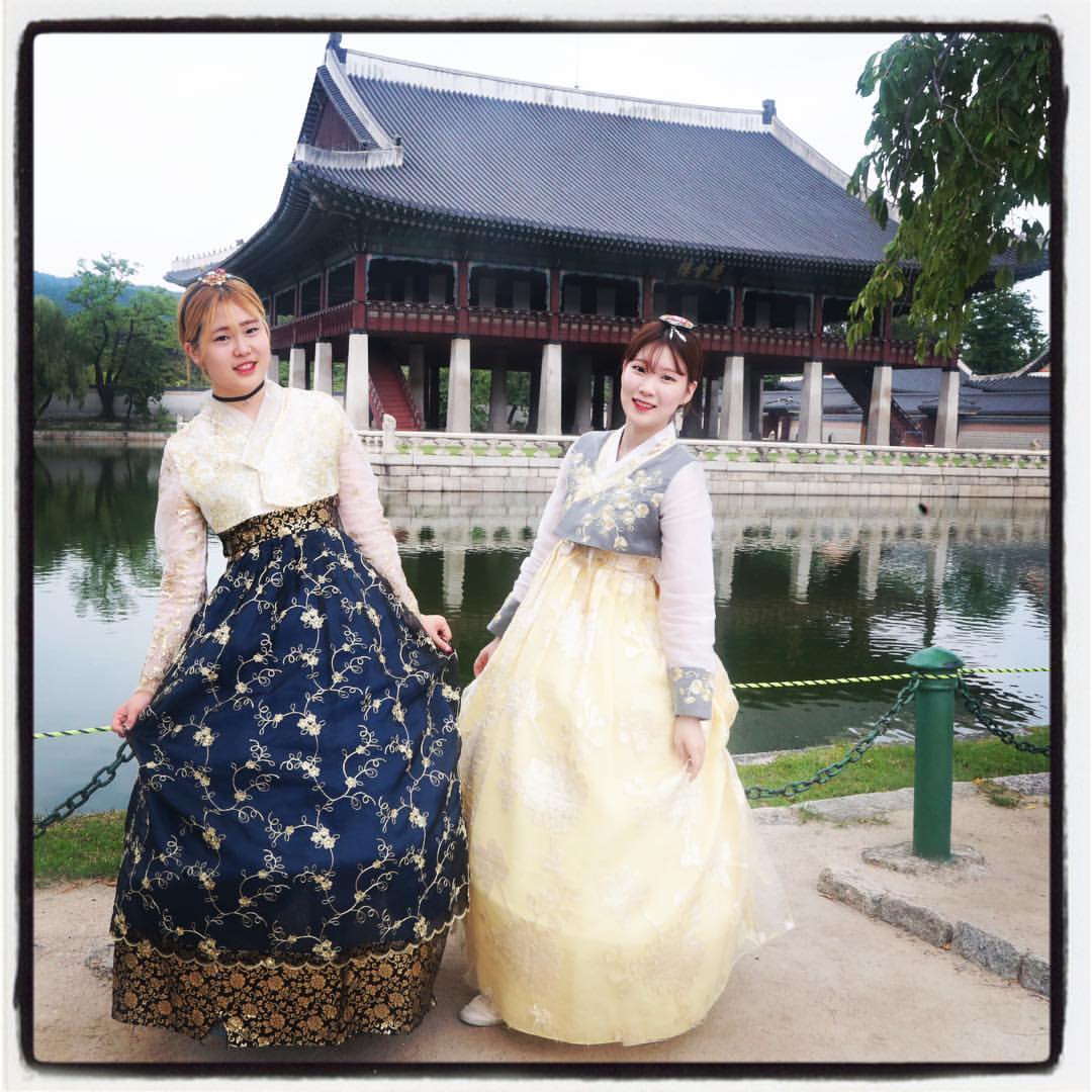Two Korean visitors to the Gyeongbok Palace "perform" Korean Tradition in the ultimate arena of Authenticity, the “souvenir shop” of national tourist sites. 