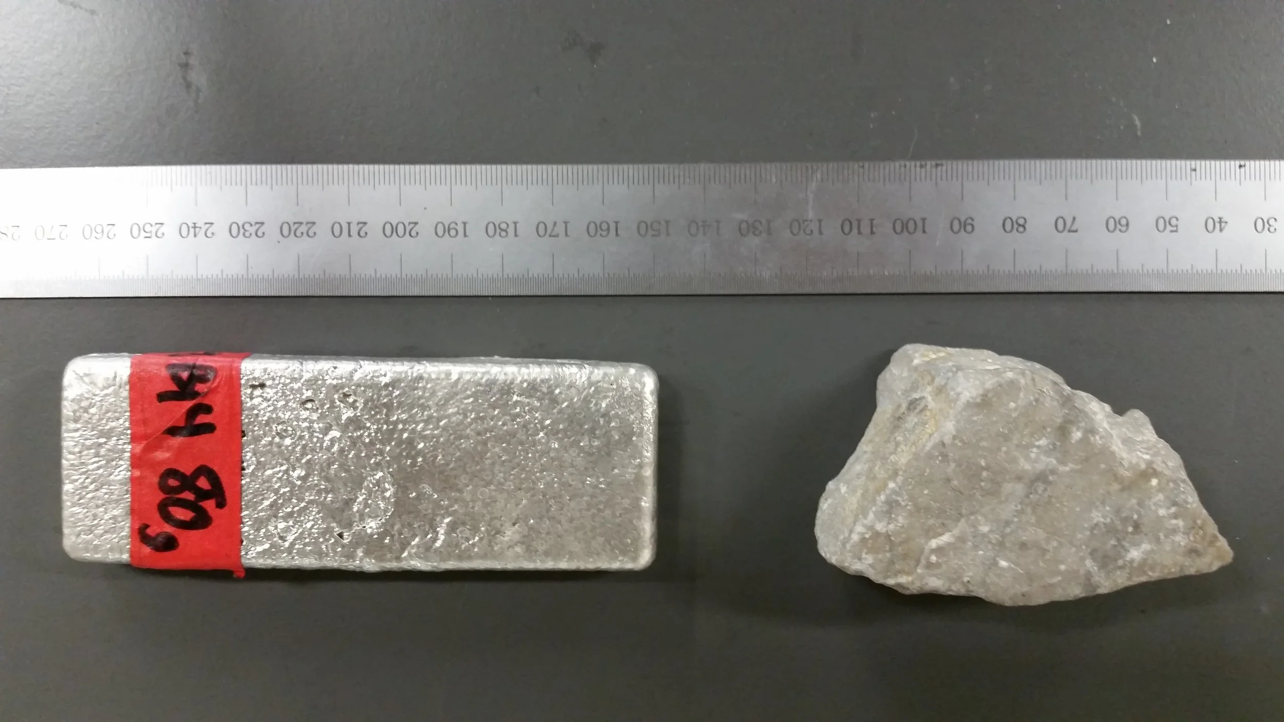 Left: Magnesium metal bar (80g) produced using silicothermic processing. Right : Dolomite rock from Addy, Washington near the defunct NorthWest Alloys plant. Photo Credit : Boris Chubukov