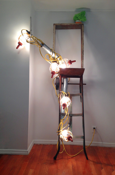  pendulous ubera, &nbsp;2014  Always suggesting the human form. moving dolly, string of construction lights, metal conduit, wooden frame, rubber nipples, jar of petroleum jelly, cleaning mitt. &nbsp;Dimensions variable. &nbsp;Currently - 76 x 56 x 29