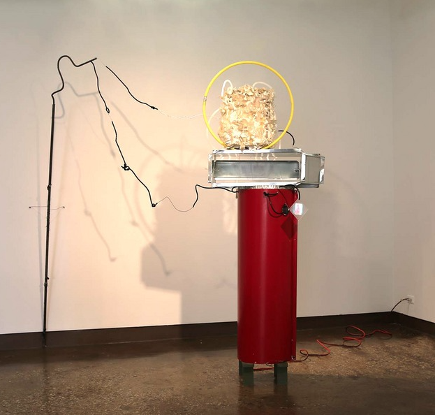  monocle &nbsp; ;  Dangling from life support, branches or an electrical matrix - a towering form sits atop Geisha shoes. Projected images of morphing body parts animate this sculpture, while cast paper leaves, drenched in epoxy seep through clear tu