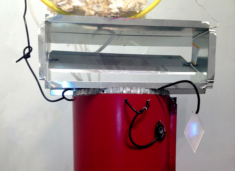  detail, monocle &nbsp;:  Orifices abound. &nbsp;One is surrounded by stethoscope tubing, highlighting and drawing the eye to an eye". &nbsp;From a projector, images of morphing body parts appear and are "captured" on a dangling plexiglass screen. 