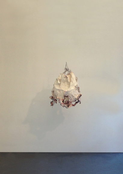  heavy &nbsp; ;  Bricks suspended inside a delicate paper mache pod make for an odd pairing.  36 x 20 x 24 inches,, 2012 paper,bricks, forceps, pins, 2012 
