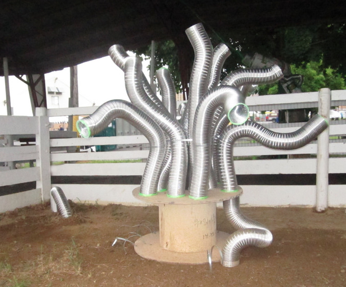  Venting &nbsp; &nbsp;;  Dryer vents move and generate sound as wind blows through them.  Outdoor, site specific installation. wire spool, dryer vents, plastic roping. 