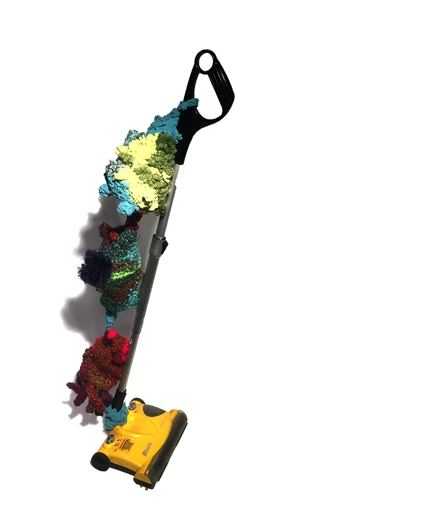 totem pods, 2015, 48 x 22 x 12 inches, hokey-vacuum, yarn, repurposed grocery bags (the stuffing). This form suggest oddly dysfunctional seed pods stacked and hung from a classic symbol of domestic labor. The vacuum was found on the street and repurposed as display - becoming part of the sculpture itself.