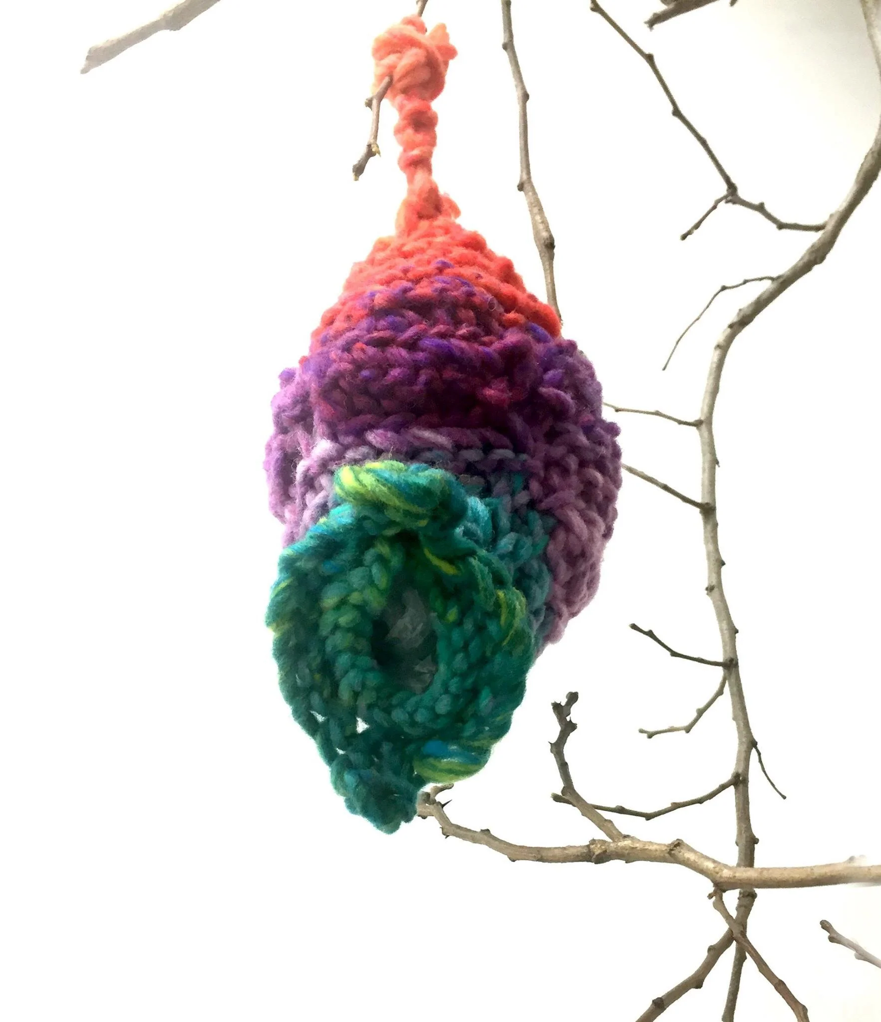  bachelor nest, cuffing season (detail)  11 x 5 x 6 inches &nbsp; yarn, up-cycled grocery bags for stuffing, tree limb.  Based on the Baya Weaver bird nest, this gendered nest reflects the power of this domestic space. &nbsp;Male birds weave a nest t