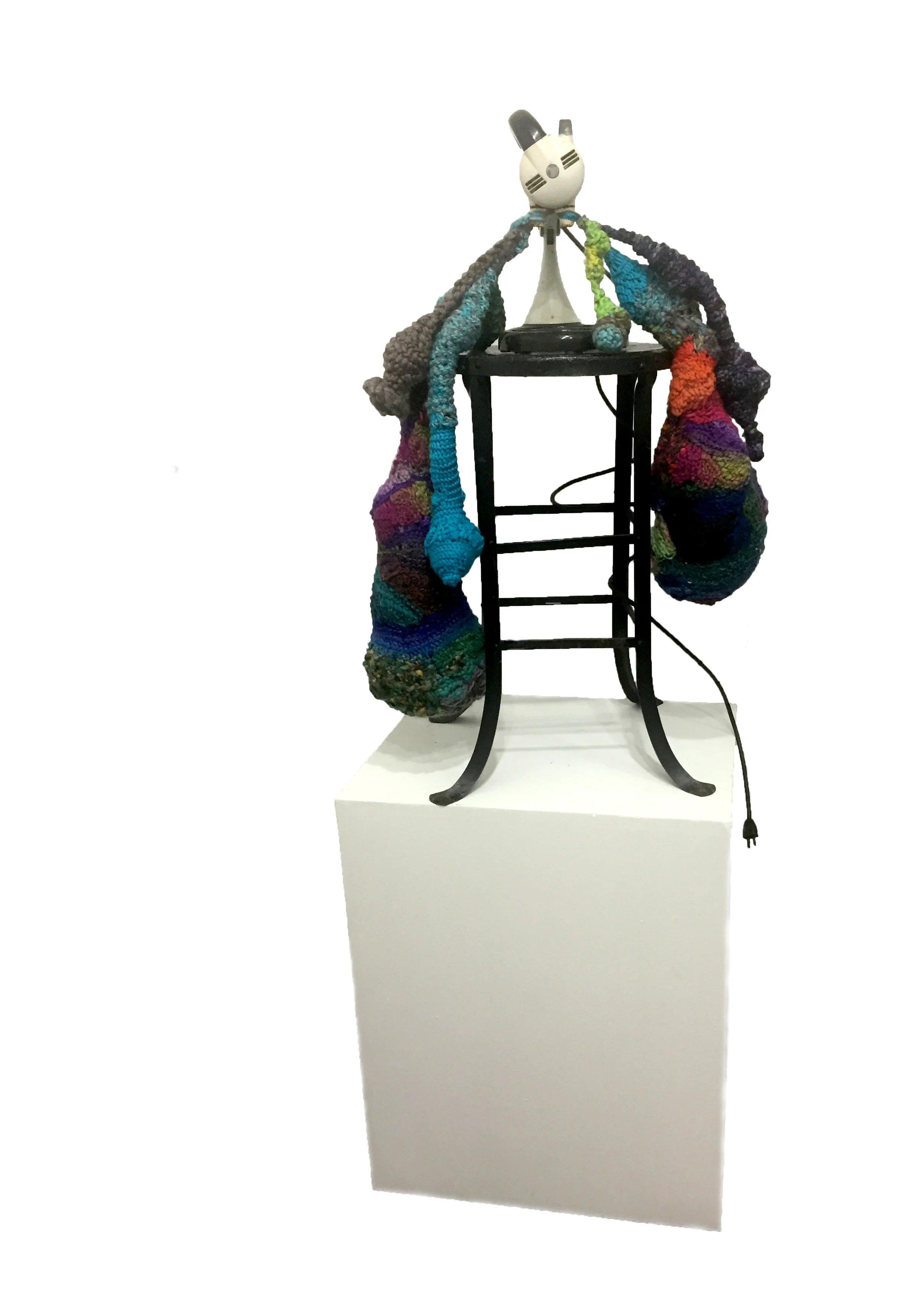 It is possible to sense the heft of hanging masses? 2018, Vintage Stand Mixer, Vintage metal stool, yarn, upcycled grocery/shopping bags (stufing), 54 x 30 x 26 inches A 1950’s era stand mixer becomes body when perched atop a vintage stool. The crocheted masses hanging from the mixer allude to the generative body, the maternal, the weight of responsibility that comes with caring for helpless living beings. The stand mixer alludes to a time in history where the “ideal” woman was sequestered in the home, confined to domestic activities and told to find happiness in the objects that would make her life easier. An entire industry was built and still persists around these gadgets. This stand mixer would have been coveted as a symbol of affluence.