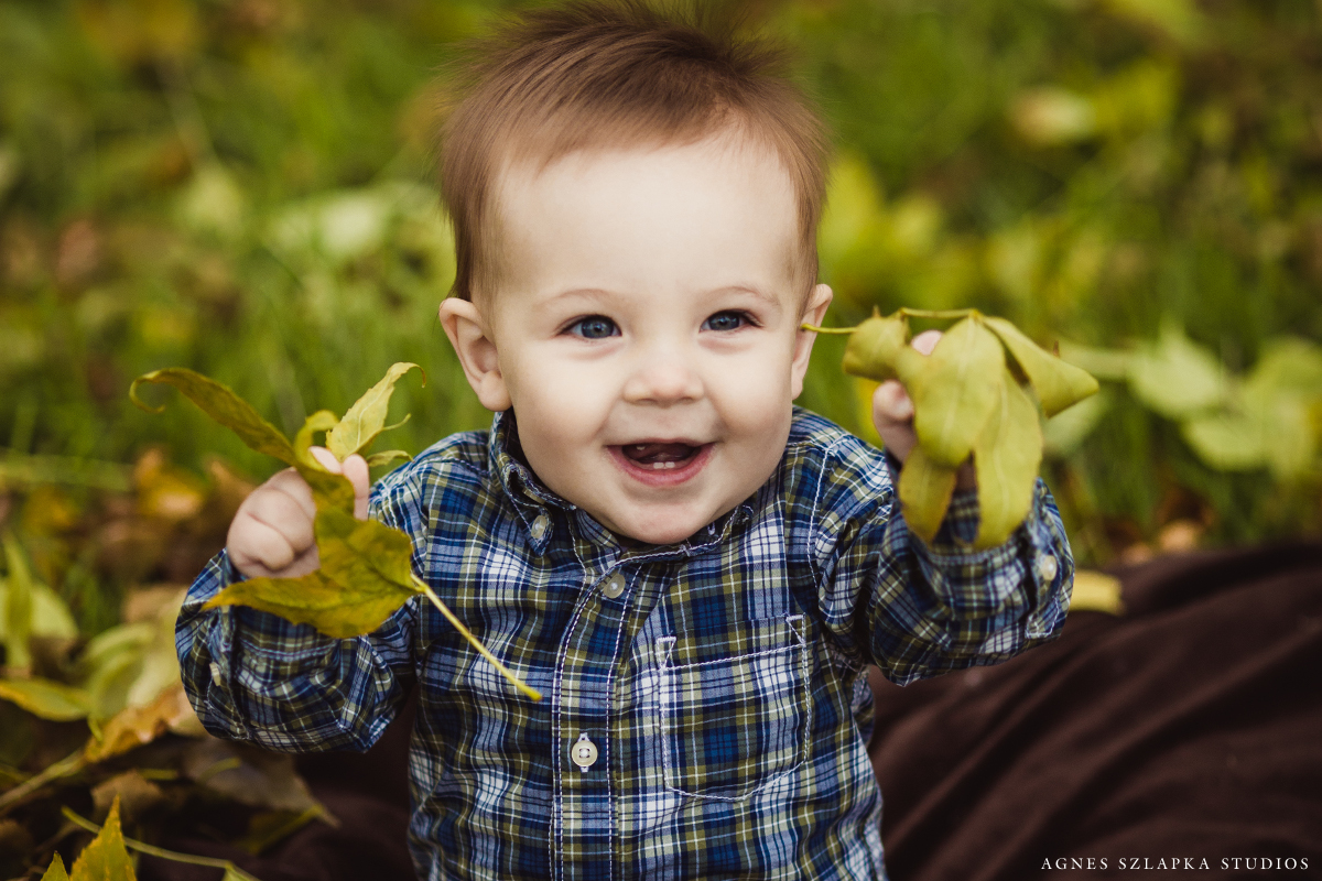 baby boy smiling holding leaves | cleveland, ohio kids photographer