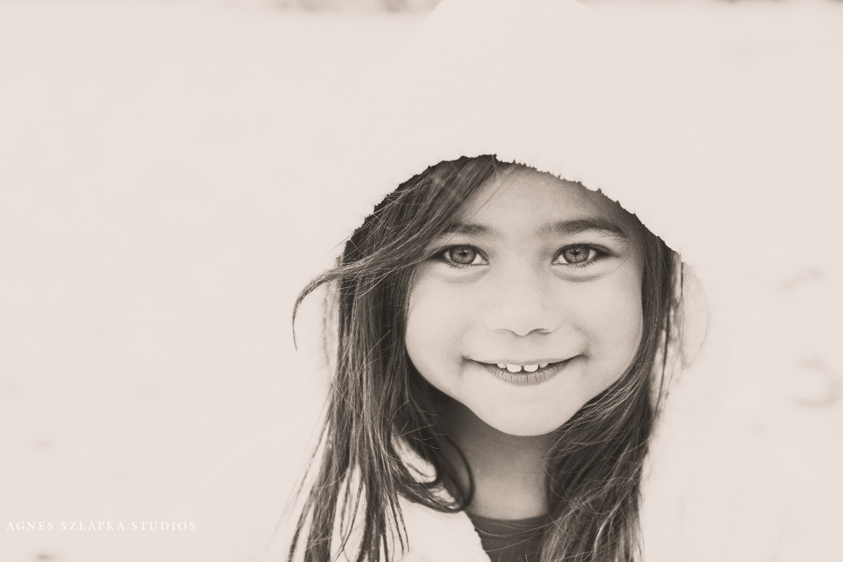 three year old girl with hood in snowy weather | cleveland, ohio kids photographer