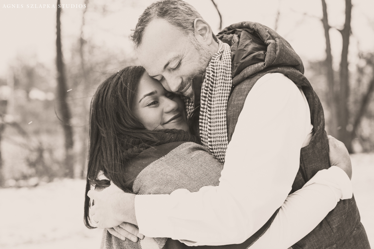 husband and wife hugging each other close on frosty day | cleveland, ohio family photographer