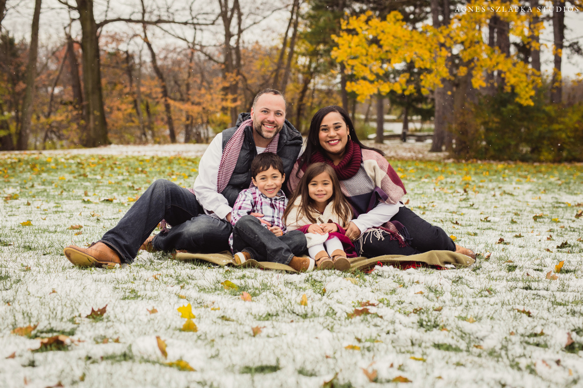 family of four sitting on blanket for winter pictures | cleveland, ohio kids portrait photos 