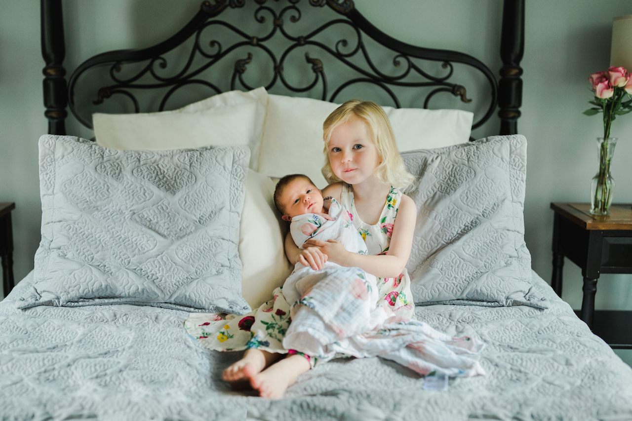 big sister holding baby sister | cleveland, ohio newborn photographer