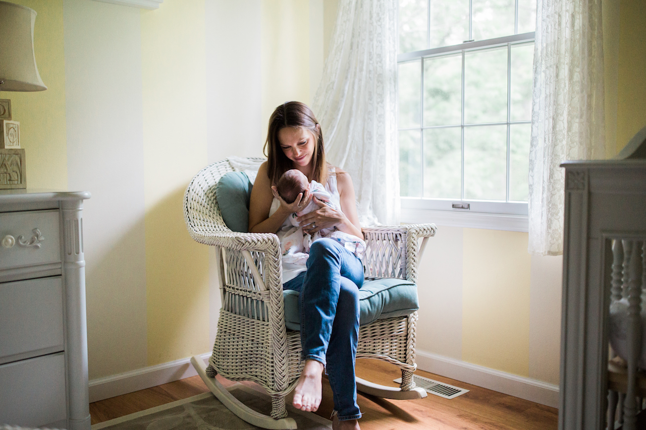 mom and baby girl in nursery | cleveland newborn lifestyle photography