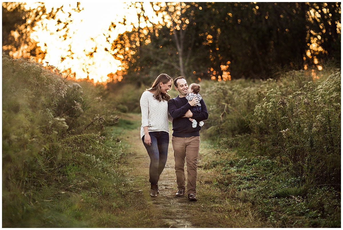 family of three walking on a nature path lakefront nature preserve | cleveland, OH newborn photos