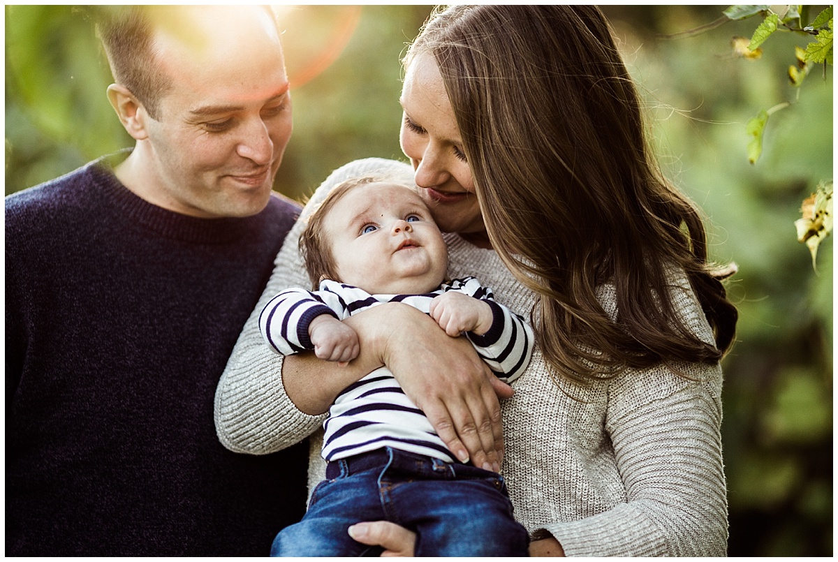 mom and dad lovingly hugging baby boy | cleveland, OH newborn photos