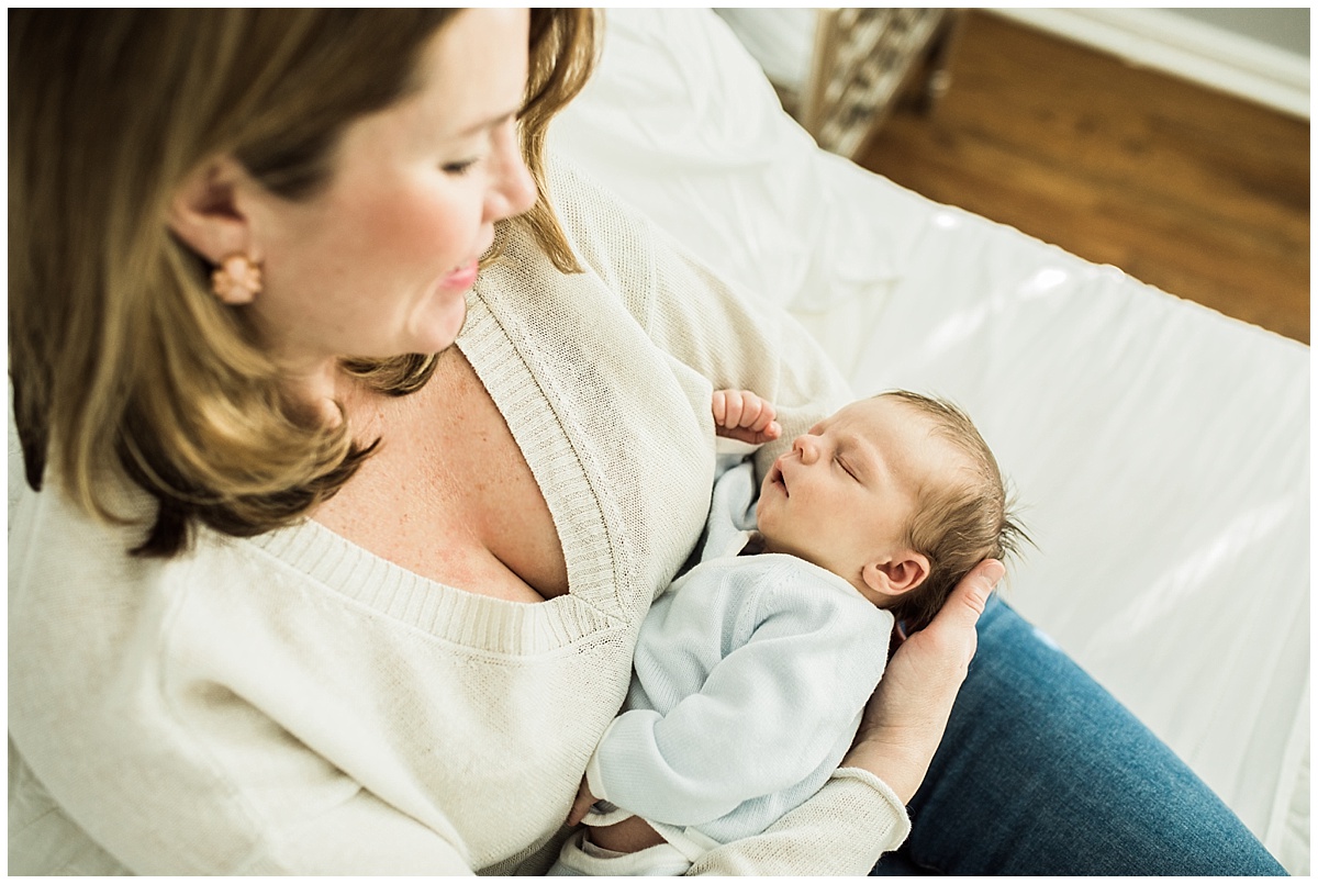 new mom holding sleeping infant son | cleveland, OH newborn lifestyle photos