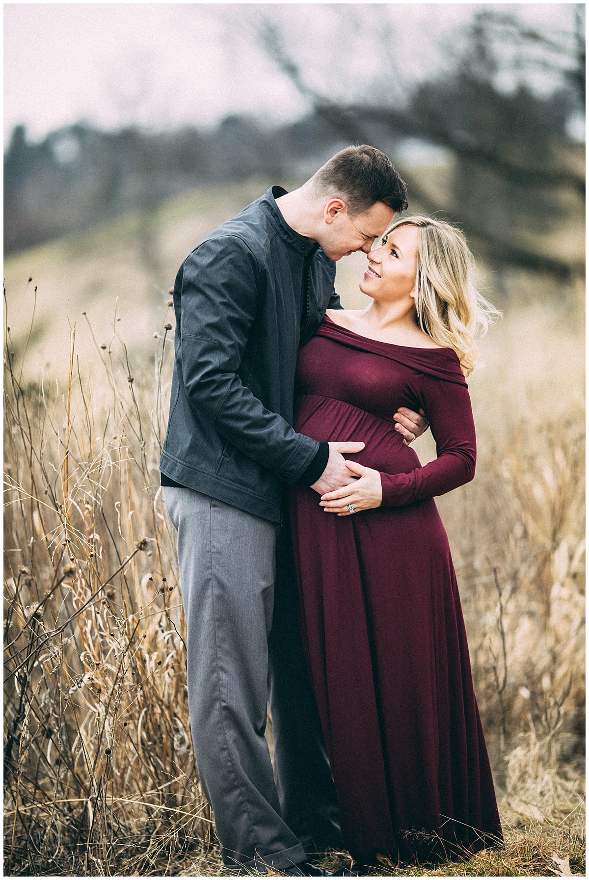 expecting parents kissing in the park | cleveland, OH maternity photographer