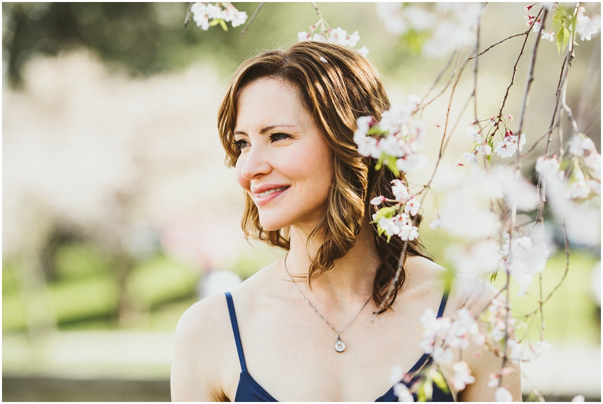 mother in blue dress amongst cherry blossoms | cleveland, oh family photographer