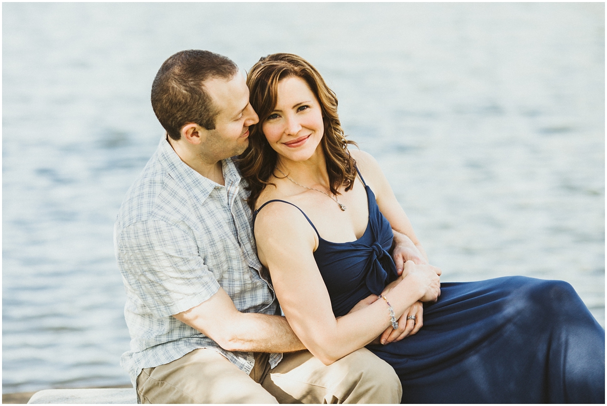 husband and with sitting on bench near pond | cleveland, OH family photographer