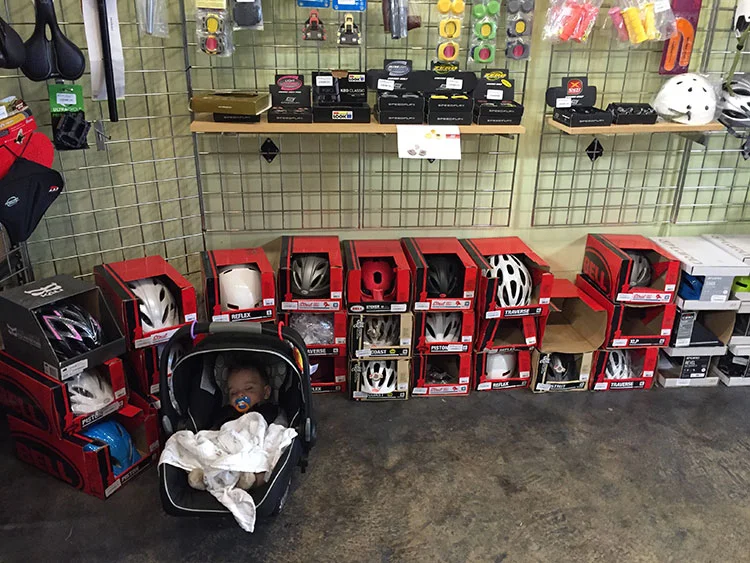 Waiting on bike repairs to be completed at Decatur Bikes, my son takes a nap.