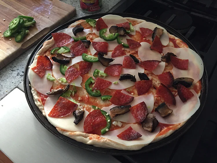 Provolone on the bottom, pre-cooked pepperoni and mushrooms to get rid of fat/moisture, fresh jalapenos for my side.