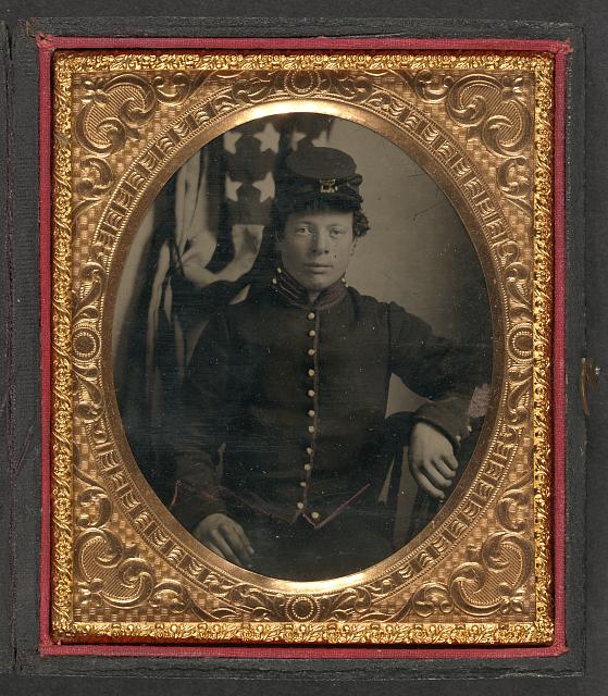 Soldier in Union Uniform Sitting in Front of the American Flag | Circa 1861-1865
