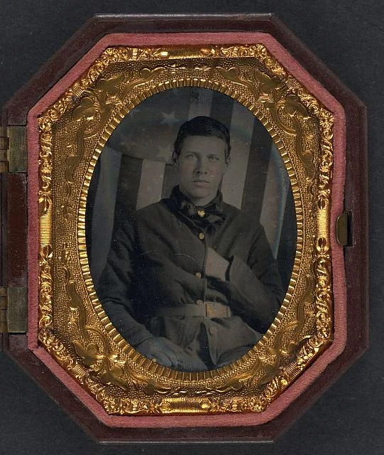 Soldier in Union Sack Coat in Front of American Flag Backdrop | Circa 1861-1865